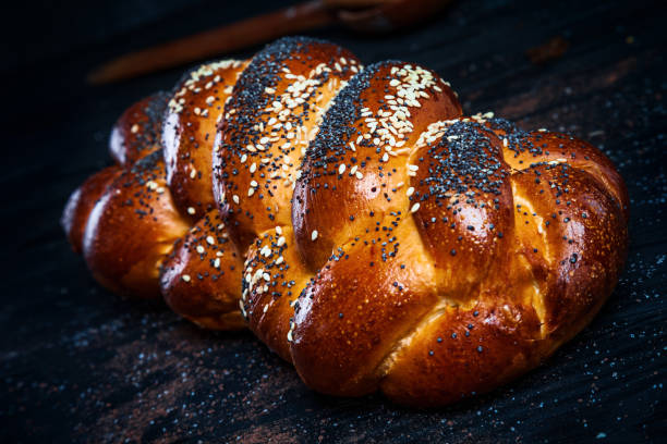 istock Fresh homemade bun with poppy seeds, with ingridients on dark rustik background. Copy space for text, brand or logo. 1053418018