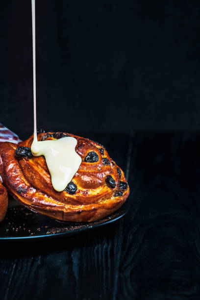 istock Homemade fresh cinnamon buns on dark plate and rustik background. 1053418846