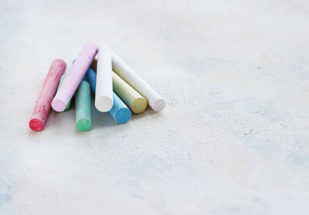 istock chalks in a variety of colors arranged on a white background 1053419304