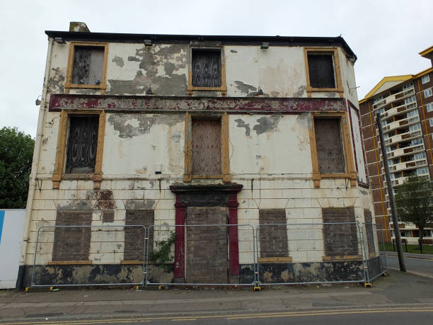 a collapsing fenced off derelict abandoned pub building in wakefield england the front of a collapsing fenced off derelict abandoned pub building in wakefield england awaiting demolition old building stock pictures, royalty-free photos & images