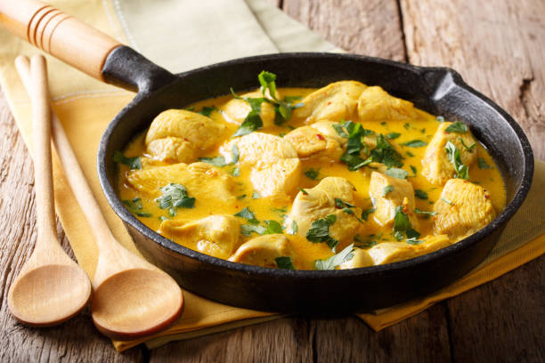 istock Chicken fillet in a spicy coconut sauce close-up. horizontal 1053423662