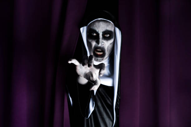 istock frightening evil nun, in a black and white habit 1053423754
