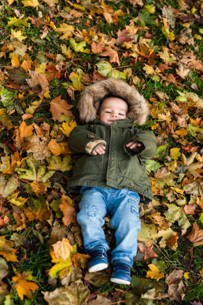 istock Baby boy on the grass in the park. 1053424672