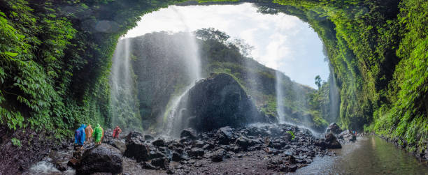 istock Panorama waterfall flowing on covered cliff in tropical rainforest 1053426638