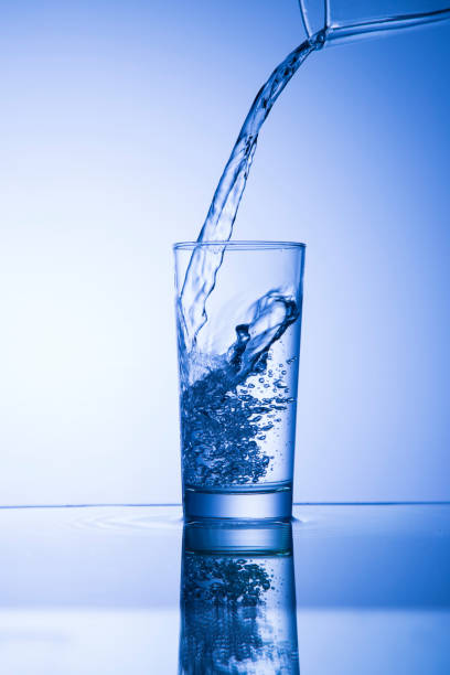 istock Pouring water into a glass 1053429506