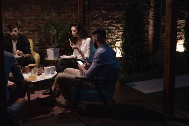 istock Group of coworkers working late and having dinner together 1053430290