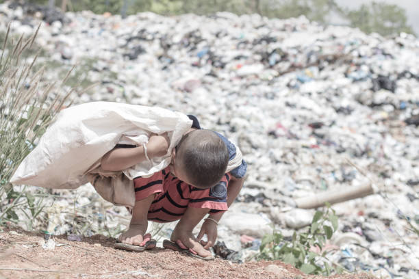 istock Poor children earn money by selling garbage. 1053433010