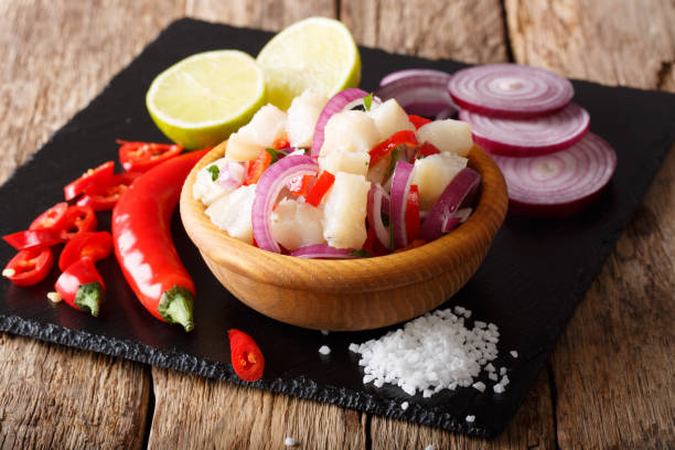 ceviche of white fish with ingredients close-up. horizontal ceviche of white fish with ingredients close-up on the table. horizontal peruvian culture photos stock pictures, royalty-free photos & images