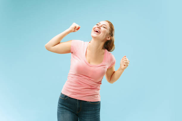 istock Winning success woman happy ecstatic celebrating being a winner. Dynamic energetic image of female model 1053436550