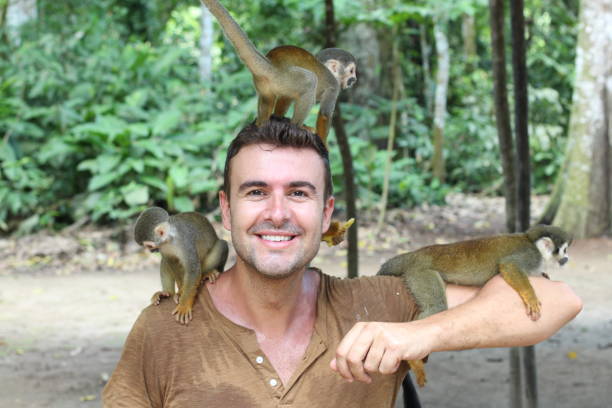 istock Handsome man with titi monkey's group 1053436840