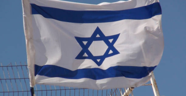 istock Israeli Flag Against Blue. Jerusalem. Israel 1053441290
