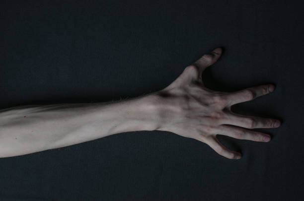istock Gothic horrible Halloween theme: thin hands of death 1053442214