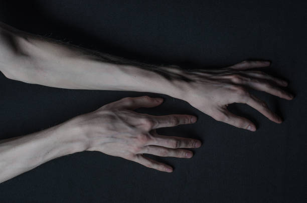 istock Gothic horrible Halloween theme: thin hands of death 1053443916