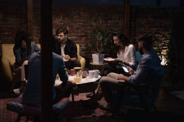 istock Group of coworkers working late and having dinner together 1053444804