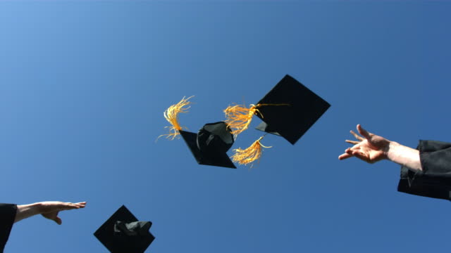 Throwing graduation caps into the air