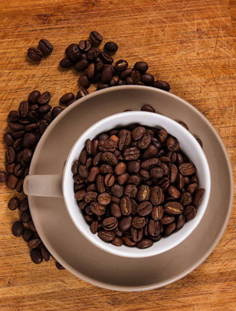 istock Close-Up Of Coffee Beans In Mug On Table 1053448376