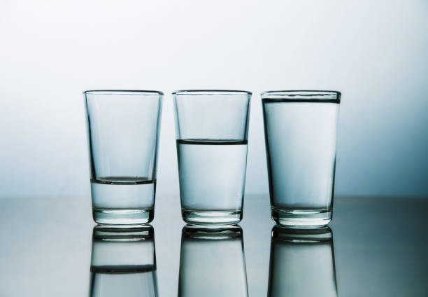 istock Glass Of Water On Table Against Wall 1053449126