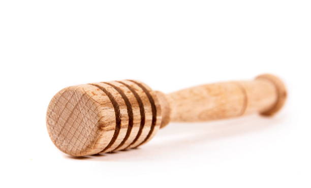 istock Close-Up Of Honey Dipper Over White Background 1053449694