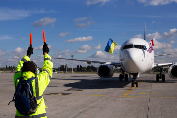 A supervisor helps at the aircraft parking stock photo