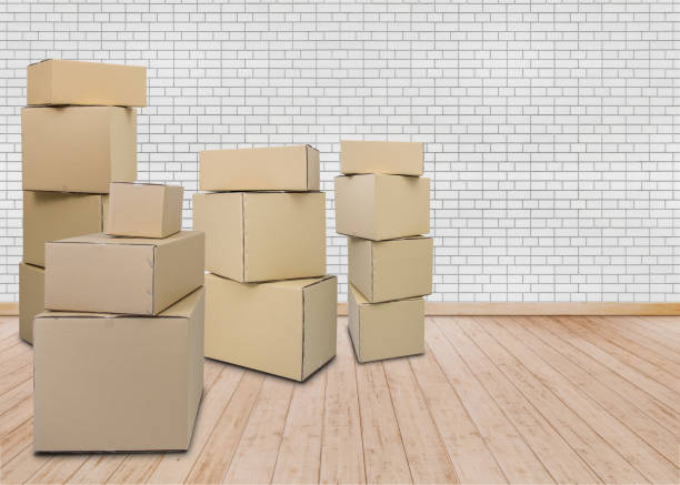 istock Moving in new home. Empty room with Carton boxes 1053455212
