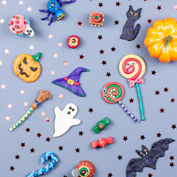 istock Halloween background with decorations. Black cat, bats, witches hat and broomstick with orange pumpkins. Top view 1053455302