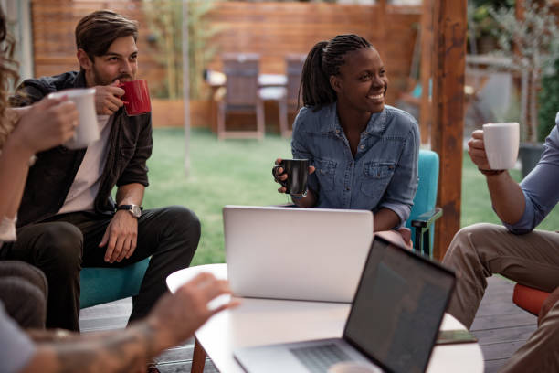 istock Little business group drinking coffee outdoors discussing new ideas 1053465228