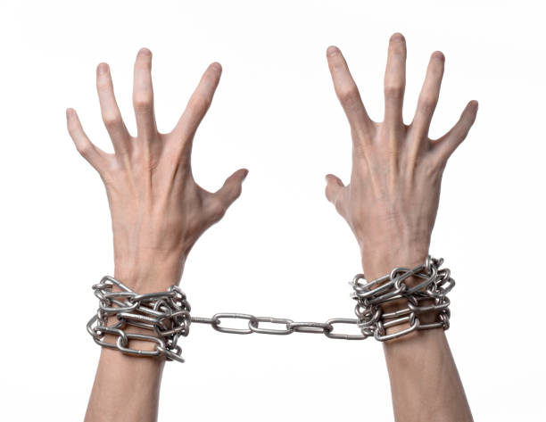 istock Social theme: hands tied a metal chain on a white background 1053466004