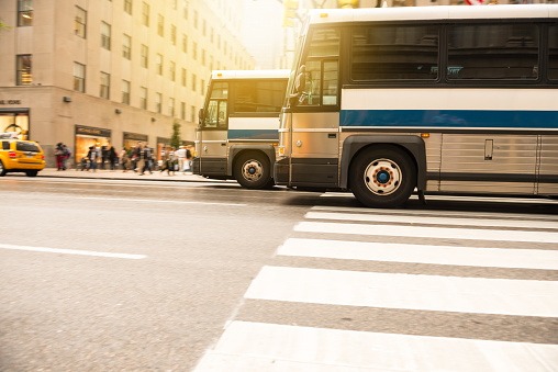 Blurred public bus transportation in lower Manhattan, Chinatown in New York City.