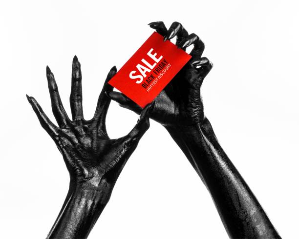 istock Black Friday theme: black hand holding a red card for a discount on white background 1053470194