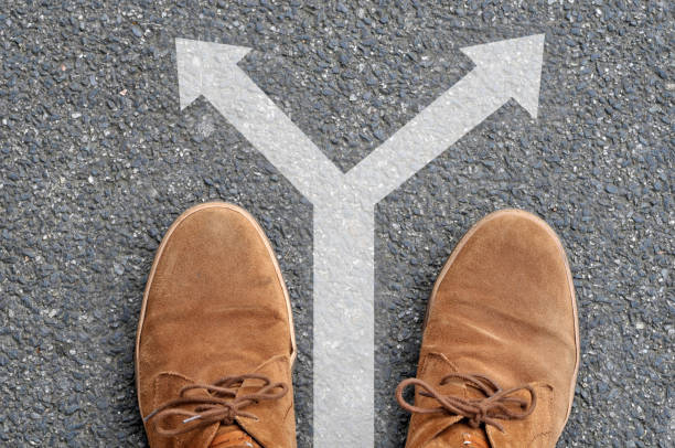 istock Shoes in front of a double arrow 1053470522