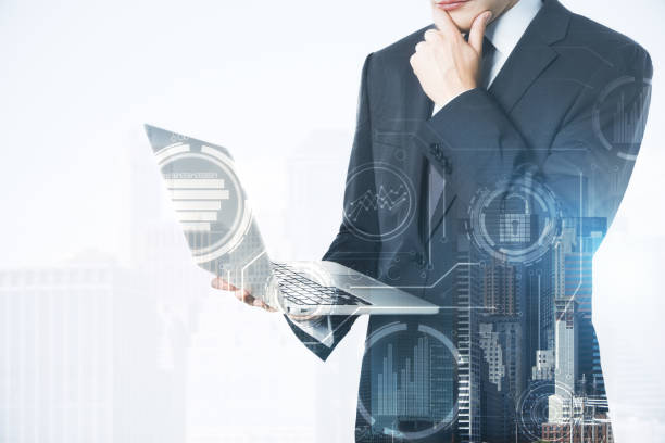istock Businessman using gadget in city 1053473914