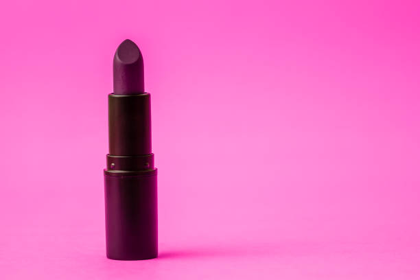 istock Dark Purple Matt Lipstick in on Pink Background 1053474318