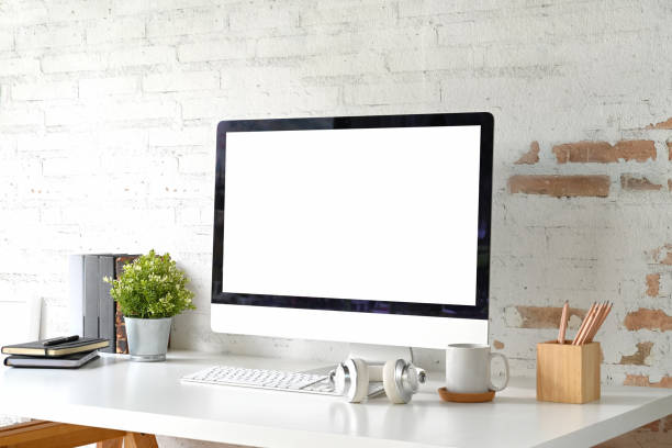 istock Loft workplace with mockup blank screen desktop computer and home office accessories 1053477994