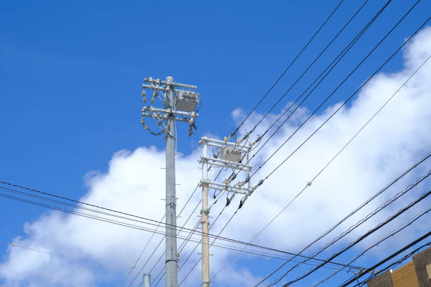 istock Low Angle View Of Power Lines Against Blue Sky 1053478928