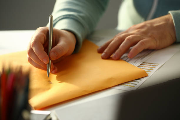 istock Male hand holding silver pen 1053479516