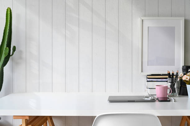 istock Stylish workspace laptop, poster, home office supplies and copy space. 1053480438