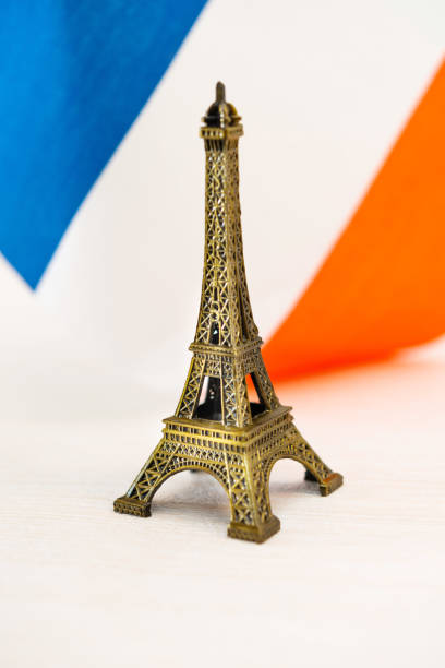 istock Metal Eiffel Tower and French flag on background 1053480608