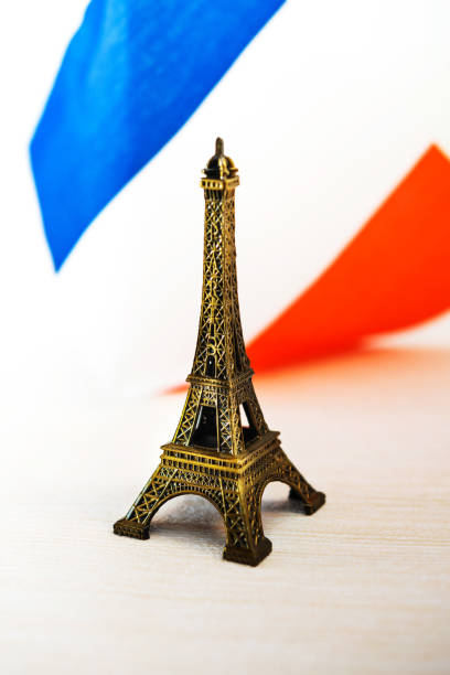 istock Metal Eiffel Tower and French flag on background 1053481020