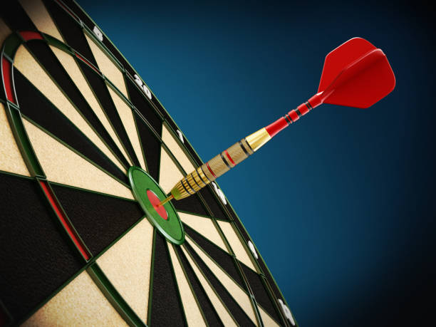 istock Red dart needle hit at the center of a dartboard 1053481308