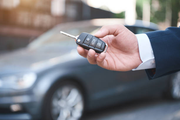 istock Dreams Come True. Young man holds the keys to a new car 1053485214