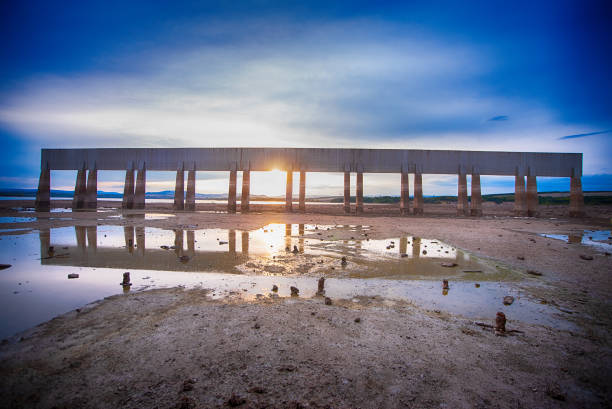 The sun set over the dam in the summer.