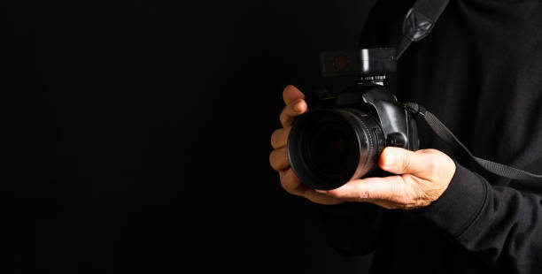 istock Person holding a camera close up 1053493994