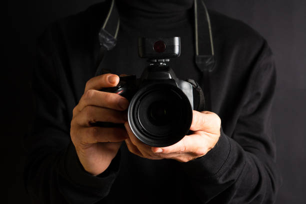istock Person holding a camera close up 1053494054