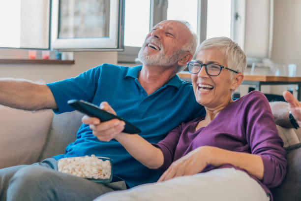 istock Smiling couple watching TV 1053494286