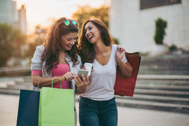 istock Best friends resting after shopping and using smart phone 1053496248