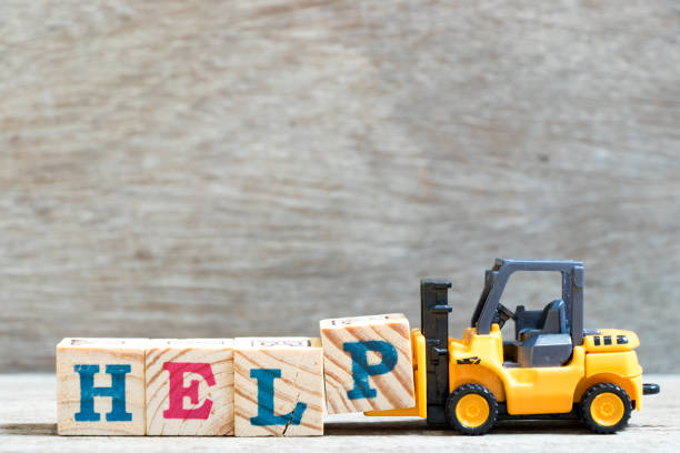 istock Toy forklift hold letter block P to complete word help on wood background 1053496458