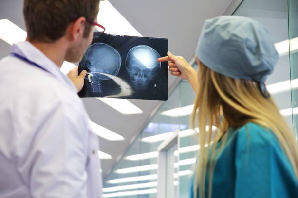 Doctors looking at the exam Doctors looking at the exam neurosurgery stock pictures, royalty-free photos & images