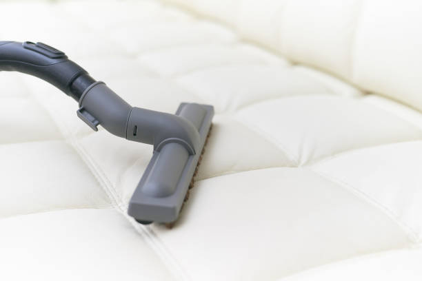 istock The vacuum cleaner brush is on the leather sofa. 1053497610