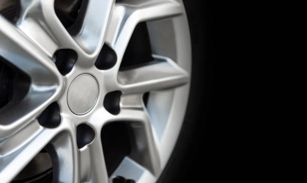 istock closeup alloy car wheels with soft-focus and over light in the background 1053499516