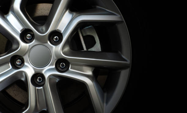 istock closeup alloy car wheels with soft-focus and over light in the background 1053499522